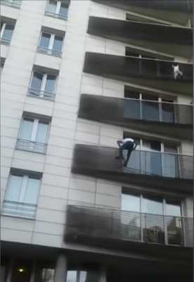 Man scales building to save dangling child